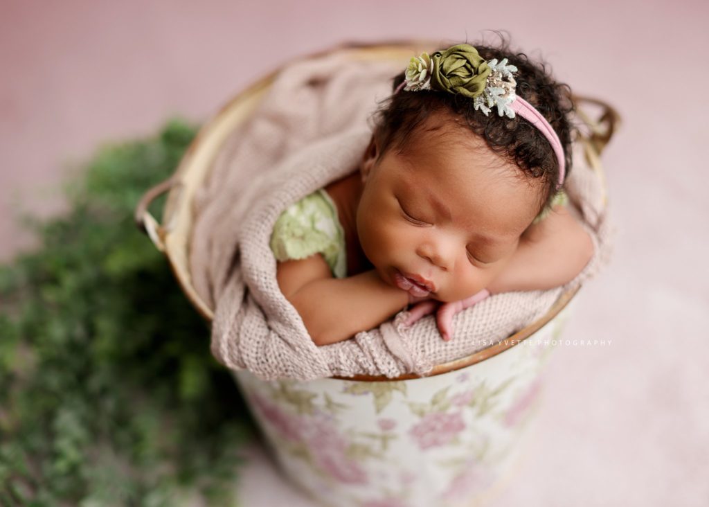 newborn in bucket pose mauve and green